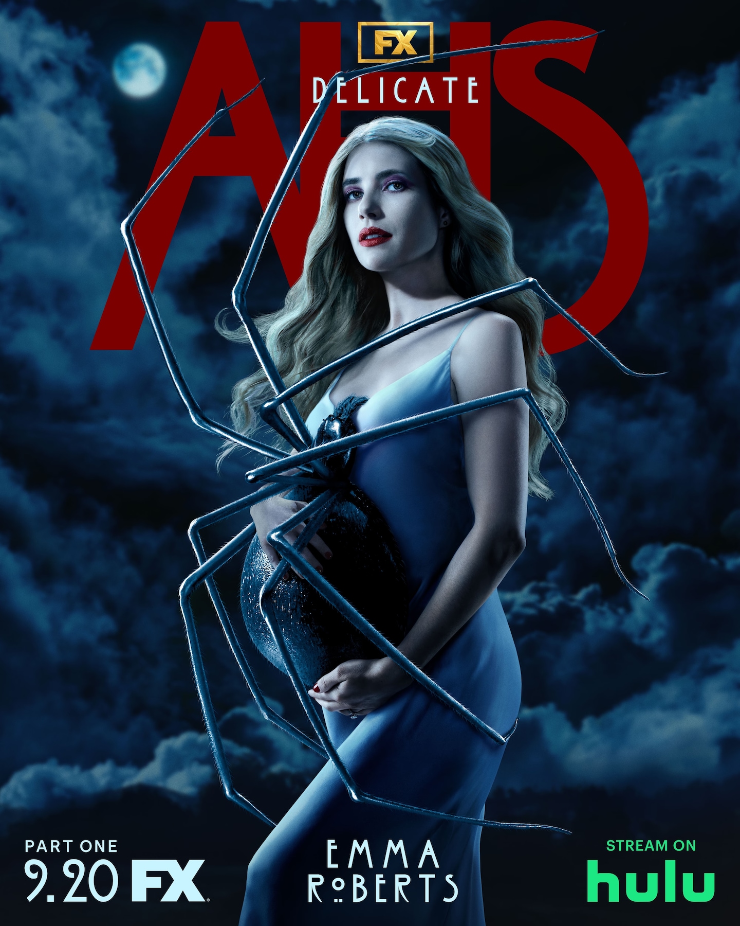 Blonde woman standing with a large spider on her stomach, in front of a dark and cloudy background for AHS: Delicate