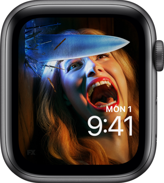 Apple Watch with lock screen of a woman screaming with a knife piercing through the wall next to her head.