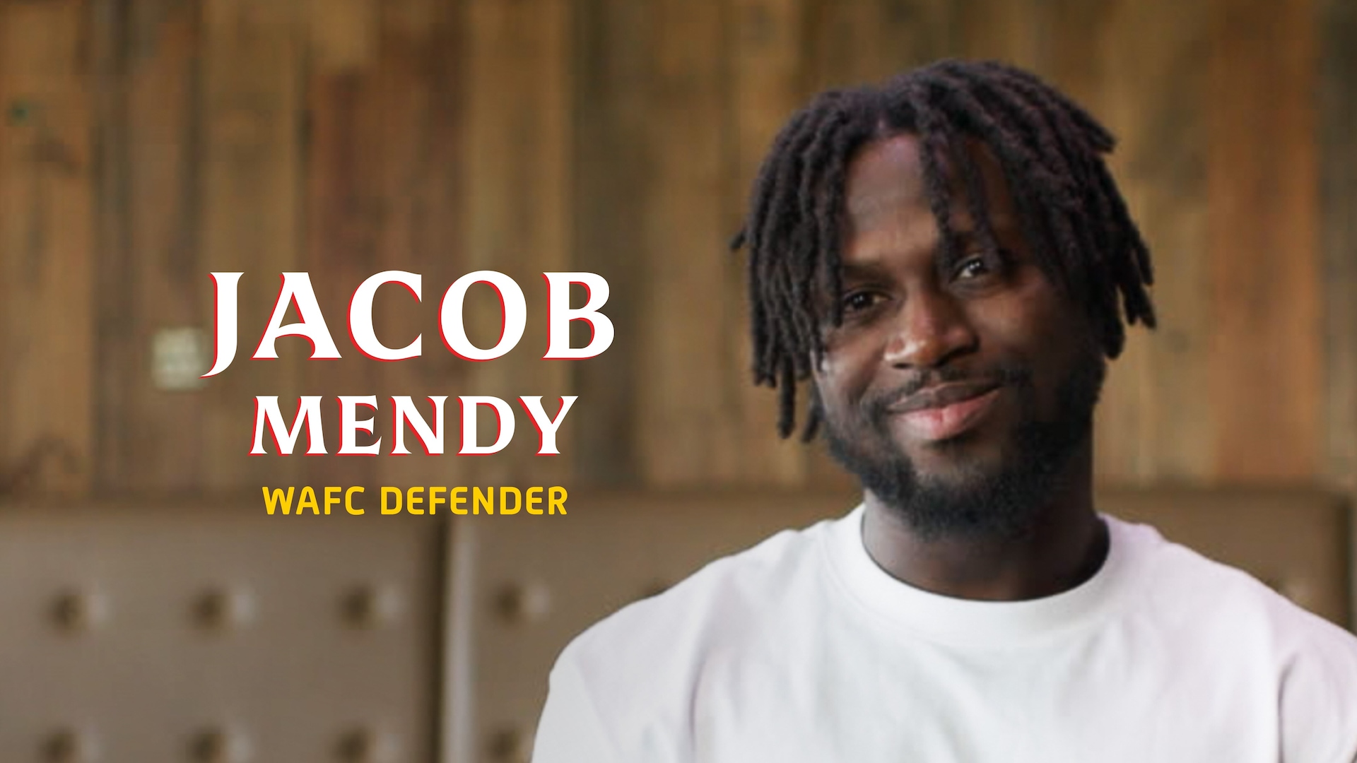 Jacob Mendy headshot wearing a white shirt, standing in front of a neutral background