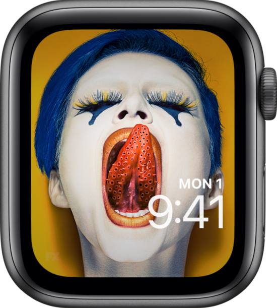 Apple Watch lock screen of blue haired woman against yellow background licking lips with holed tongue from FX's AHS Cult
