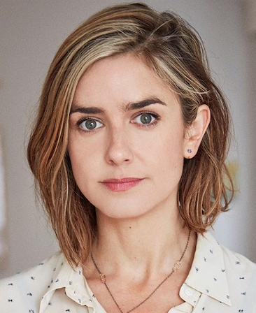 Headshot of Gina Welch wearing a white patterned button up.