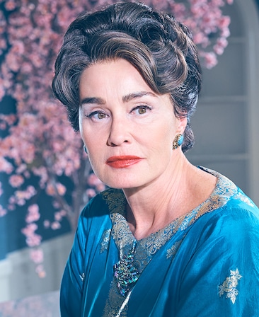 Jessica Lange as Joan Crawford wearing blue gown and blue earrings and cherry blossoms in background in Feud FX show