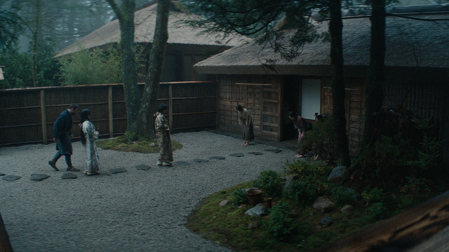 Blackthorne and Mariko walk through the courtyard of his new Ajiro home following Fuji