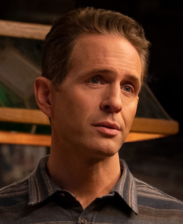 Glenn Howerton headshot wearing a striped shirt with collar and buttons