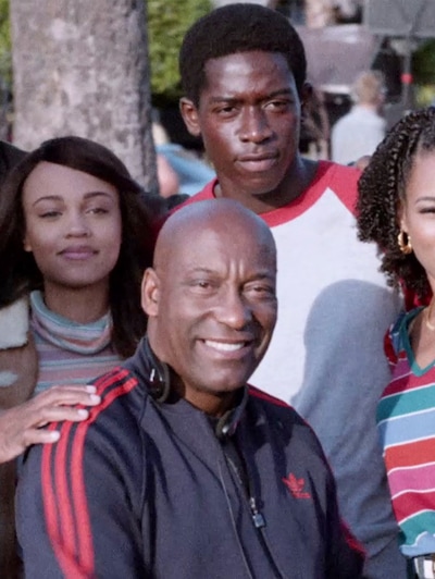 John Singleton and Snowfall cast on set smiling for a photo