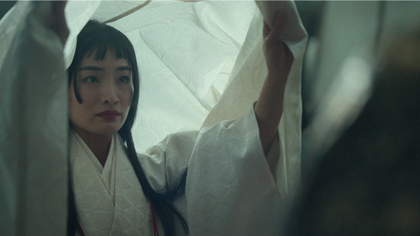 Close up of Mariko dressed in her white wedding attire