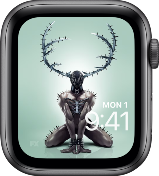 Apple Watch lock screen of muscular man on hands and knees wearing black mask and spiked antlers from FX'S AHS NYC
