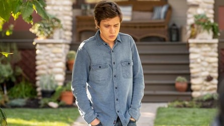 Nick Robinson wearing a denim shirt with his hands in his pockets