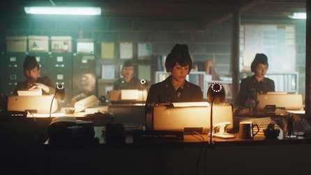 Several woman sitting in an office using typewriters 