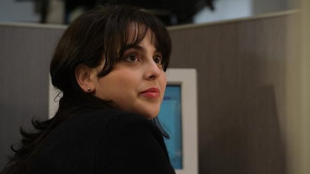 Beanie Feldstein as Monica Lewinsky in American Crime Story Impeachment looking up from white computer