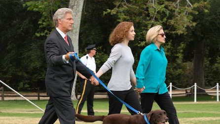 Clive Owen as Bill Clinton walks dog and holds hands with his daughter and his wife Hillary Clinton played by Edie Falco