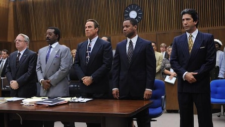 Cuba Gooding Jr as OJ Simpson in court room standing with legal team in American Crime Story Installment 1