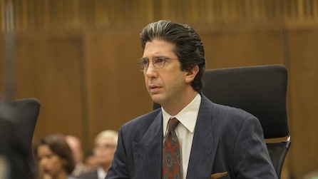 David Schwimmer as Robert Kardashian wearing glasses and sitting in court room in American Crime Story Installment 1
