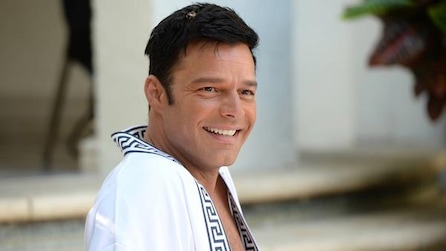 Ricky Martin as Antonio D'Amico wearing white robe and smiling in American Crime Story Installment 2