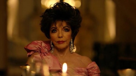 Joan Collins as Evie Gallant in pink shoulder bowtie dress and dangling earrings at dinner table in AHS Apocalypse