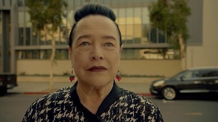 Kathy Bates as Ms Miriam Mead in black and white houndstooth shirt and red dangling earrings in AHS Apocalypse