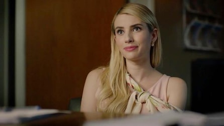Emma Roberts as Madison Montgomery in light pink top and shoulder tie sitting in front of desk in AHS Apocalypse
