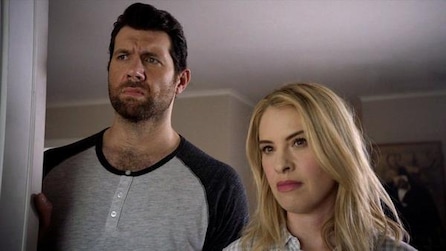 Billy Eichner as Harrison and Leslie Grossman as Meadow standing by doorway inside house in AHS Cult