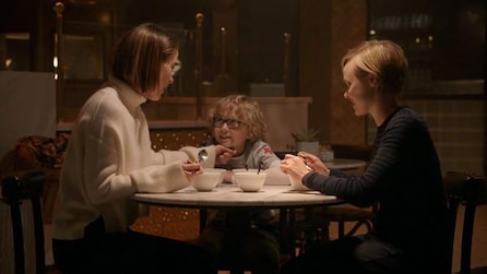 Sarah Paulson as Ally and Alison Pill as Ivy sitting at table with bowls and their son in AHS Cult