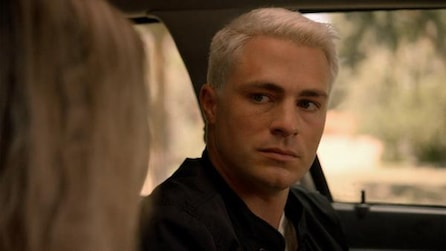 Colton Haynes as Detective Jack Samuels with platinum blonde hair inside car looking at obscured passenger in AHS Cult