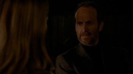 Denis O'Hare in checkered blazer looking toward obscured face of Sarah Paulson in AHS Roanoke