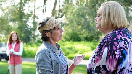 Louie Anderson as Christine in talking to woman in sun hat and golfing gear with golfing friend in background in FX's Baskets