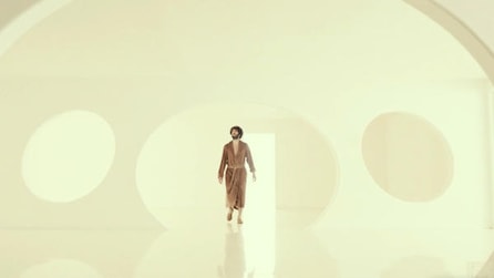 Dave in brown robe walking in ethereal white lighted dome room in FX's Dave