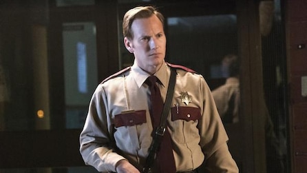 Patrick Wilson as Lou Solverson in brown police uniform with black shoulder holster inside station in FX's Fargo Year Two