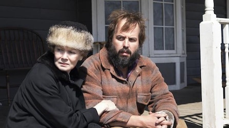 Angus Sampson as Bear Gerhardt sitting with woman holding onto his arm on house porch in FX's Fargo Year Two