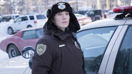 Carrie Coon as Gloria Burgle wearing police winter uniform and hat in parking lot covered in snow in FX's Fargo Year Three