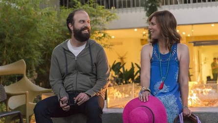 Man and woman sitting next to each other on a ledge