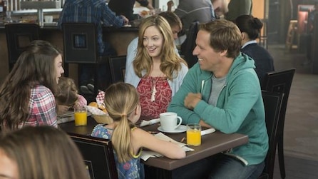 Couple and kids having breakfast at a table