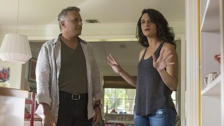 Man and woman standing next to each other in a living room