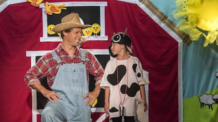 Man and kid dressed up as a cowboy and cow for a play
