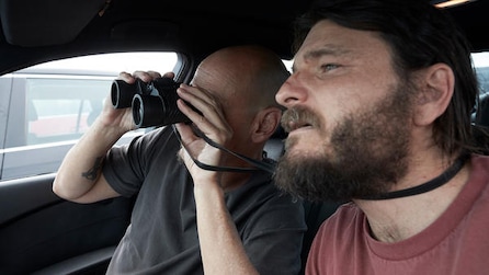 Ray and Gary using binoculars to look out the car window