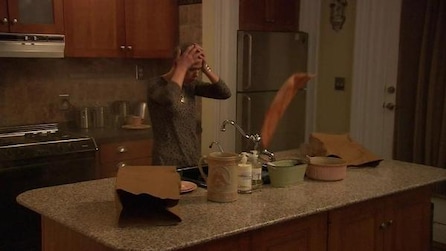 Man with his hands on his head and standing in the kitchen