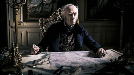 Old man sitting at a marble table with a pen in his hand
