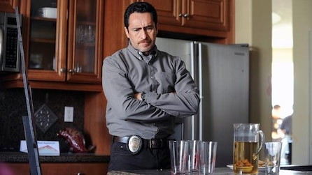 Demian Bichir as Marco crossing arms looking down inside house kitchen in FX's The Bridge