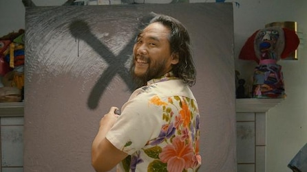 David Choe spray painting black X on canvas turned over shoulder smiling in floral shirt in FX's The Choe Show