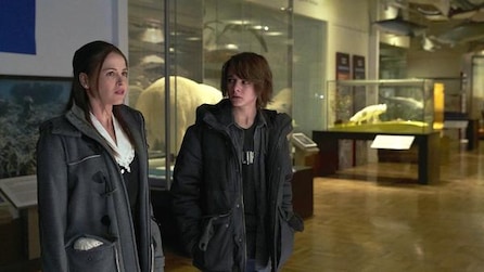 Two people standing in the middle of a museum