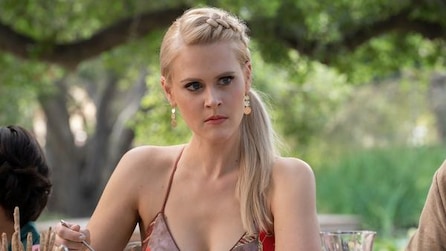 Blonde girl wearing a tank top with an angry expression on her face