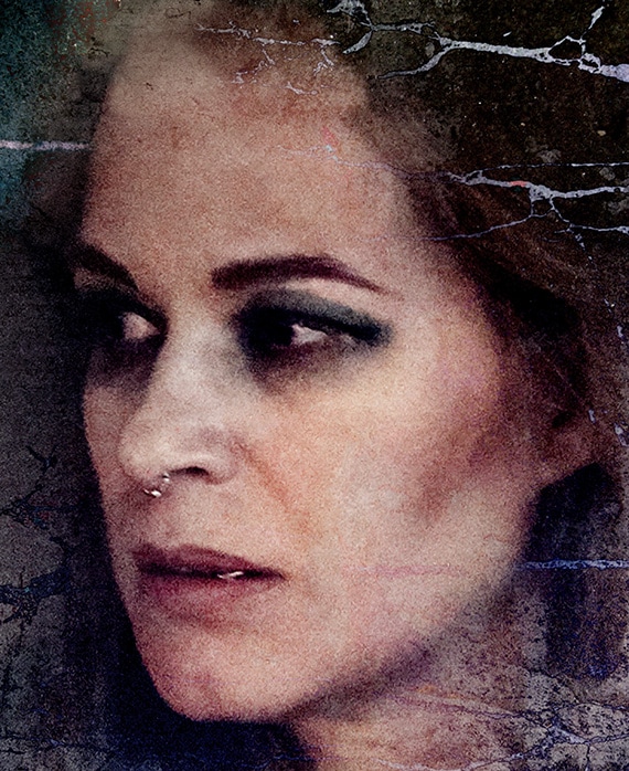 Franka Potente Headshot looking to the right wearing heavy eye makeup and nose ring