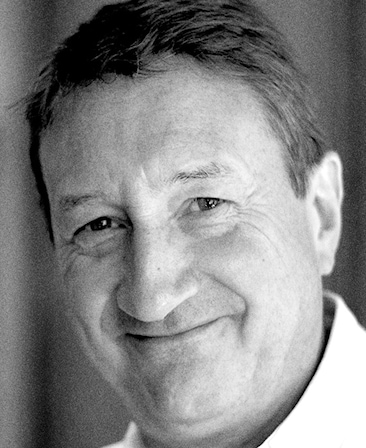 Steven Knight Headshot smiling in a black and white filter