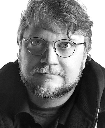 Guillermo del Toro Headshot wearing glasses with a black and white filter