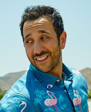 Desmin Borges headshot wearing a blue shirt with flamingos on it