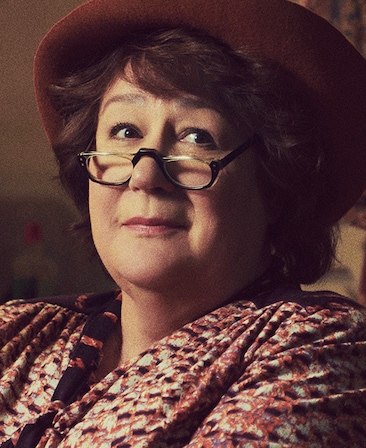 Margo Martindale headshot wearing a red hat and glasses
