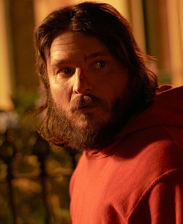 Justin Rosniak headshot wearing a red hoodie