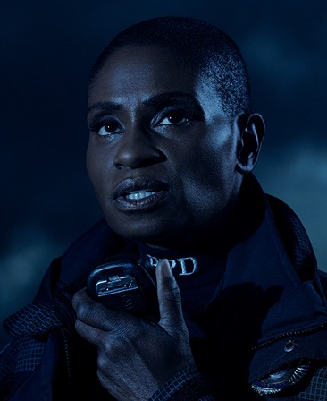 Headshot of Adina Porter in police uniform holding receiver microphone under moonlight from FX's AHS Double Feature