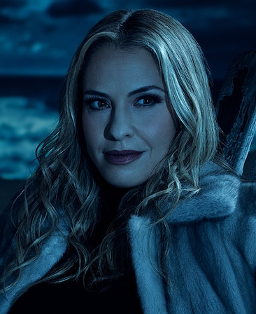 Headshot of Leslie Grossman in white fur jacket under moonlight on cloudy night from FX's AHS Double Feature