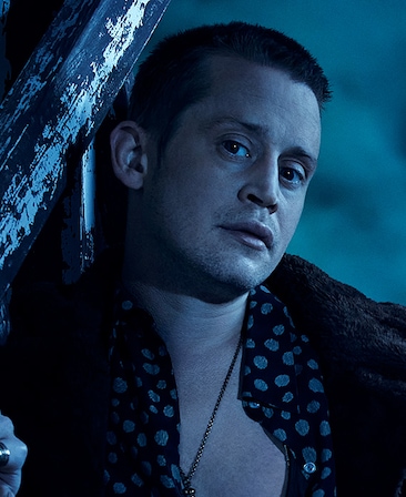 Headshot of Macaulay Culkin in open button down and jacket under moonlight on cloudy night from FX's AHS Double Feature